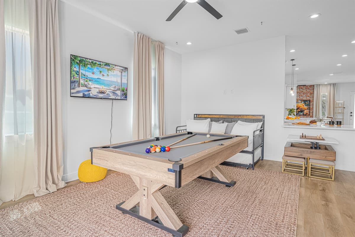 Spacious entertainment area with pool table and open layout connecting seamlessly to the rest of the home.
