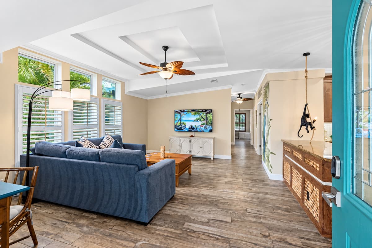 This open and airy living room features bright natural light, comfortable seating, and seamless access to the home's common areas.