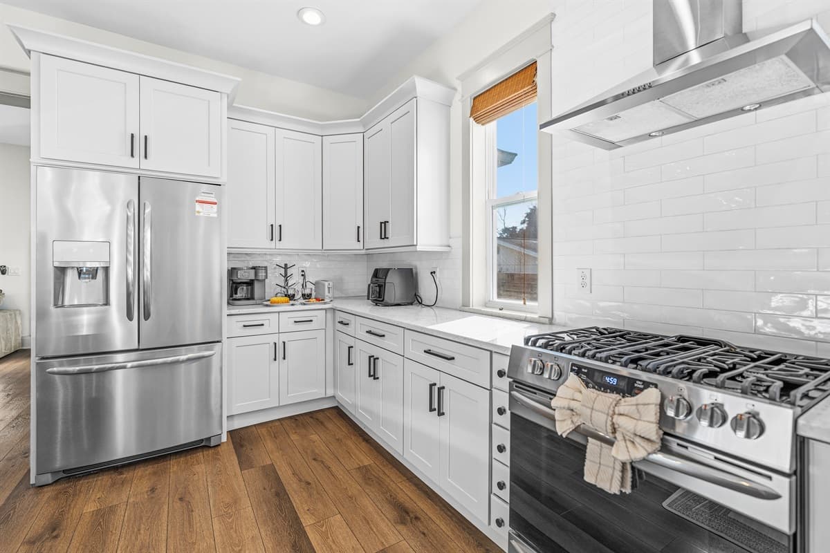 Brand-new stainless steel French door refrigerator and professional gas range — all fully stocked and ready for your stay. This Seminole Heights kitchen has everything you need to cook, gather, and entertain in style.