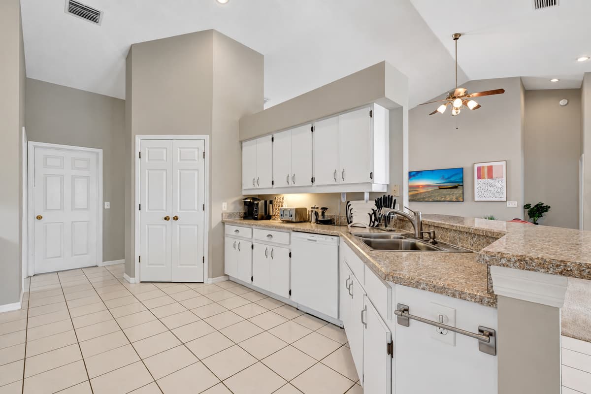 The spacious countertops, also in pristine white, offer plenty of room for food preparation, allowing you to unleash your culinary creativity.