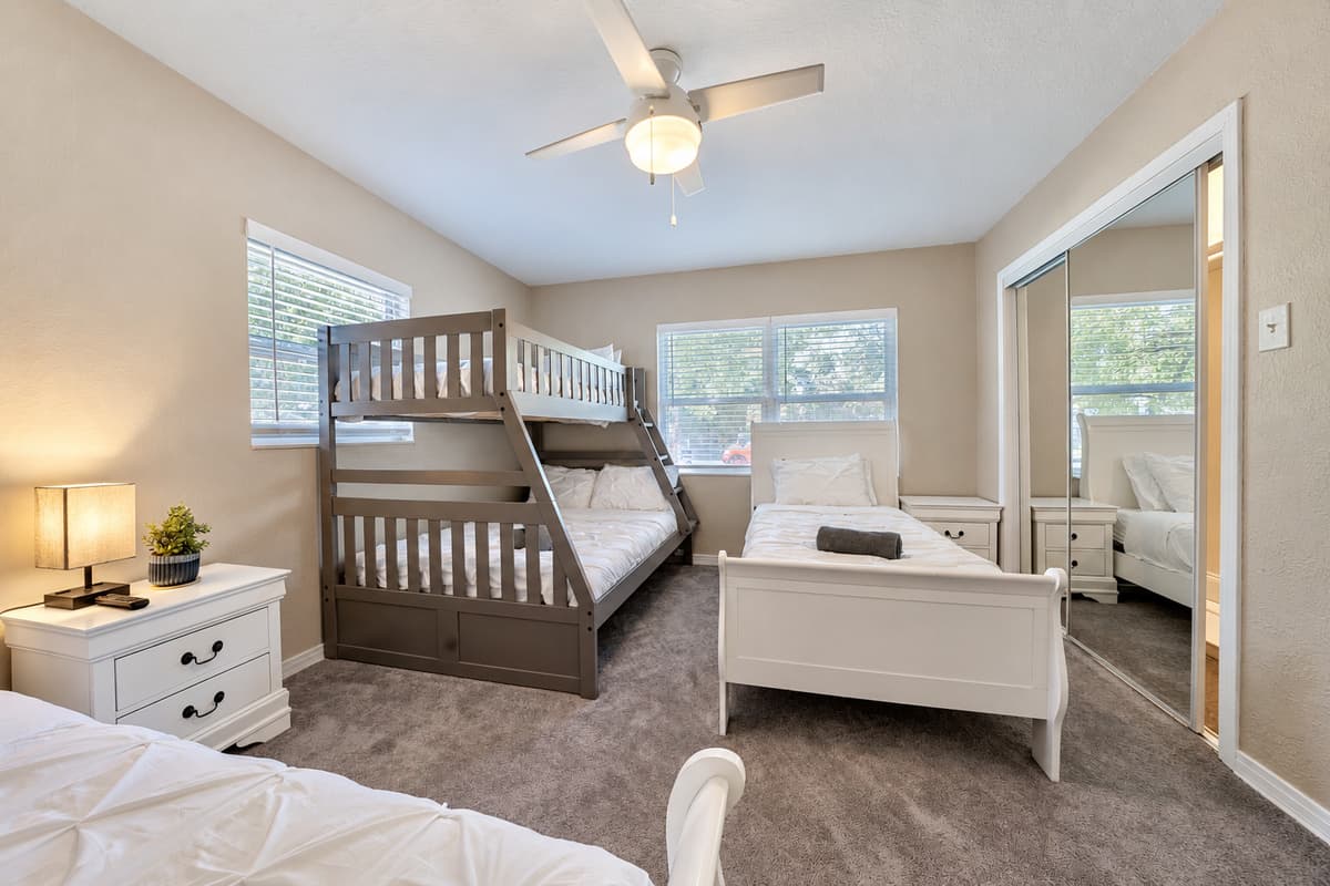 In this spacious bedroom, you'll find two comfortable twin-size beds along with a bunk bed, making it an ideal space for families, friends, or guests who prefer their own sleeping arrangements.