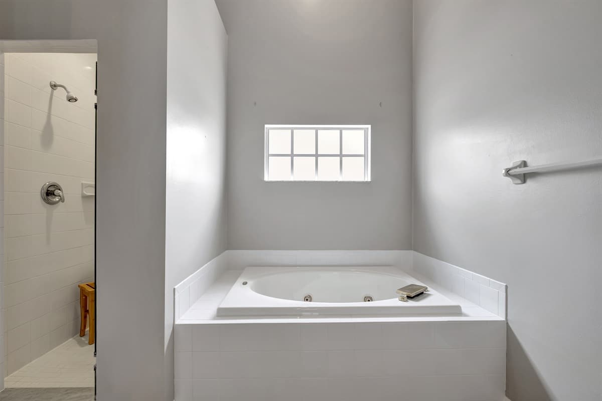 The pristine white-painted walls and spotless tiled surfaces create a sense of purity and serenity.