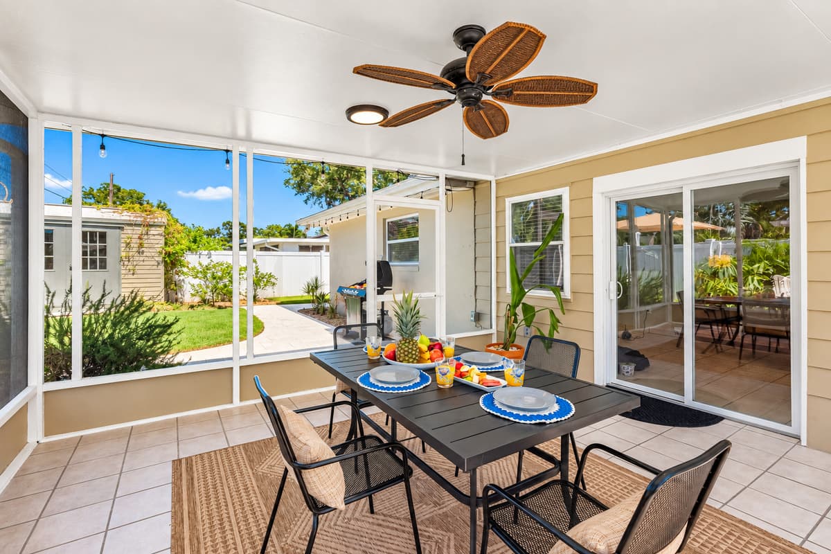 This charming patio offers a breezy, shaded space for outdoor meals or cocktails with friends. With a view of the pool and tropical landscaping, it's ideal for relaxing in comfort and style.