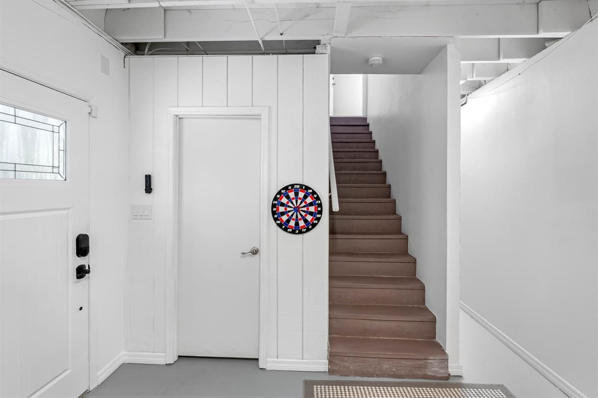 A welcoming entry that doubles as a mini game zone with a dartboard — perfect for quick fun before heading upstairs.