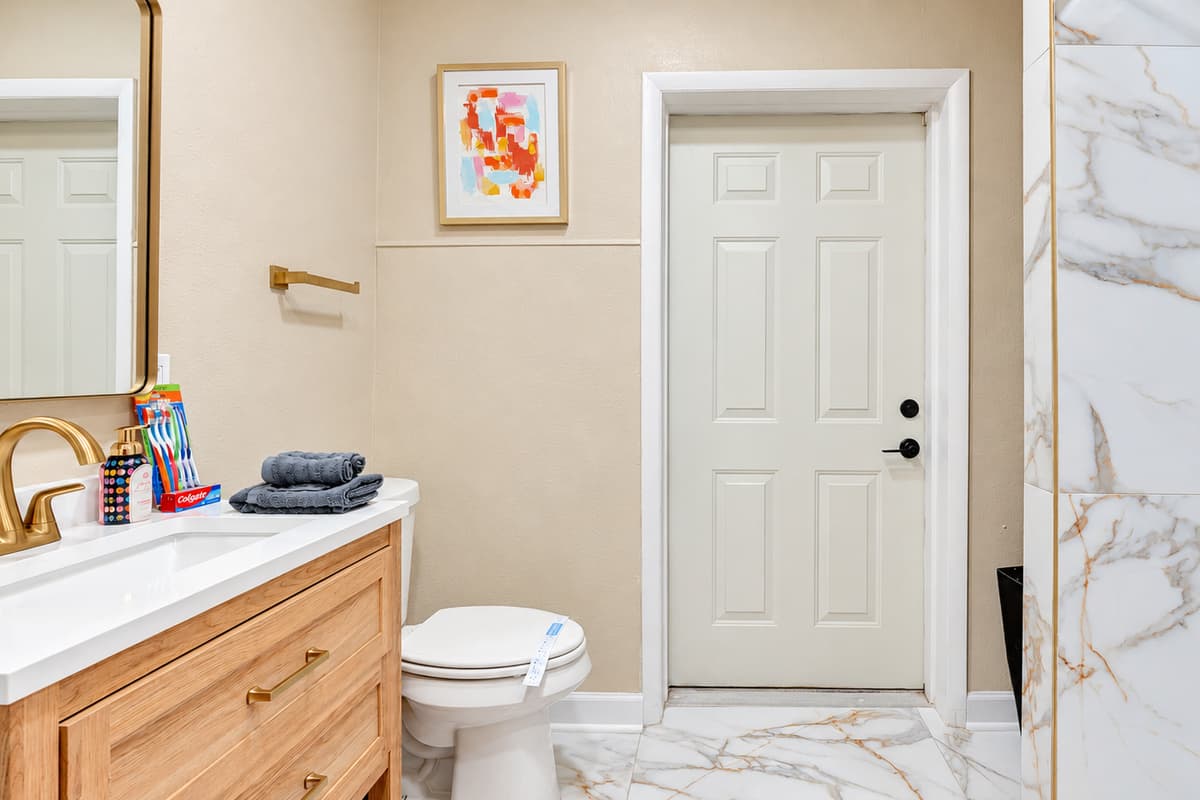 The lavish cream, marble, and gold combination exudes sophistication and luxury.