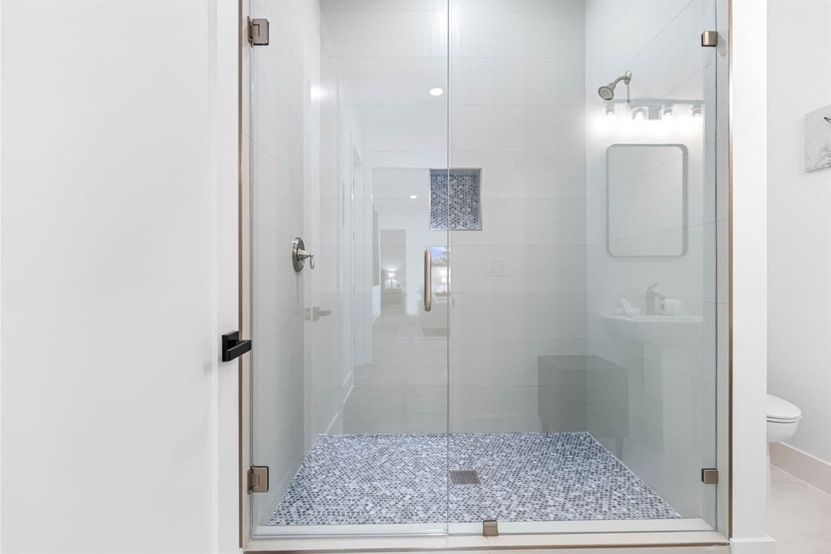 The sleek walk-in shower adds a modern touch.