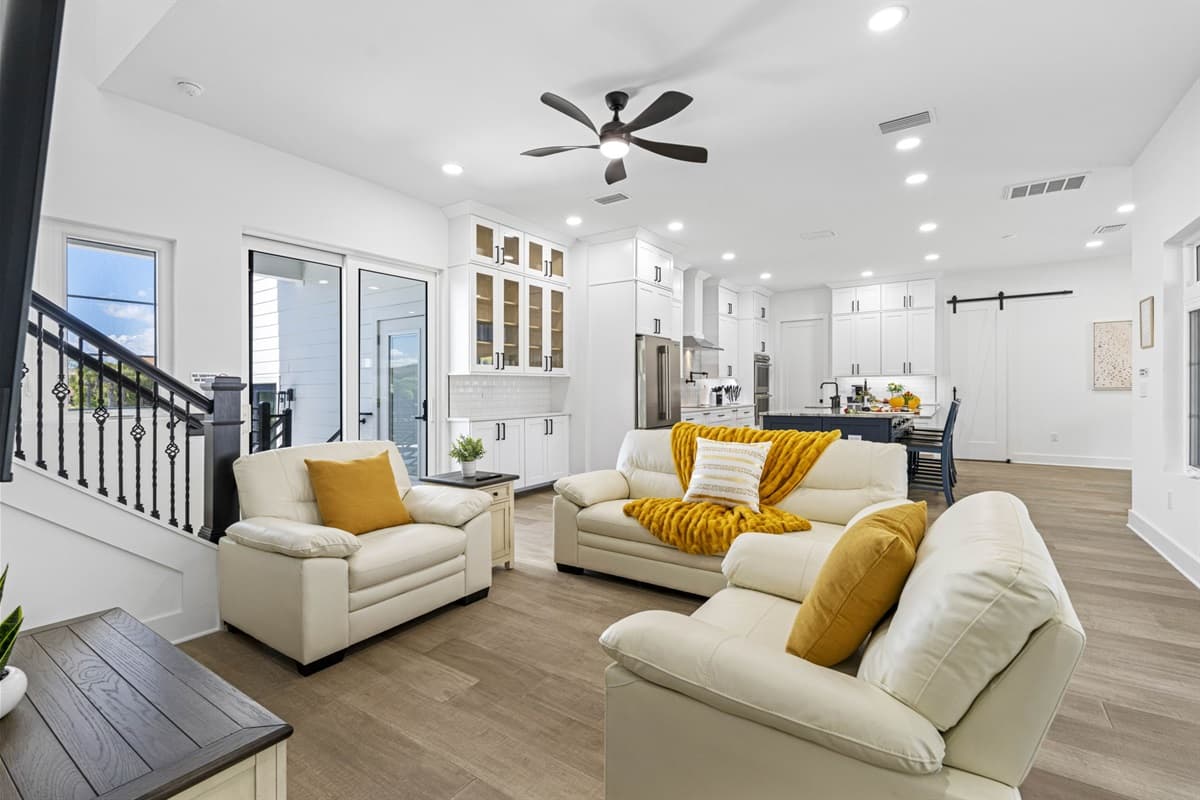 The main living room is a hub for gathering, featuring stylish furnishings, cozy seating, and a large flat-screen TV for entertainment.