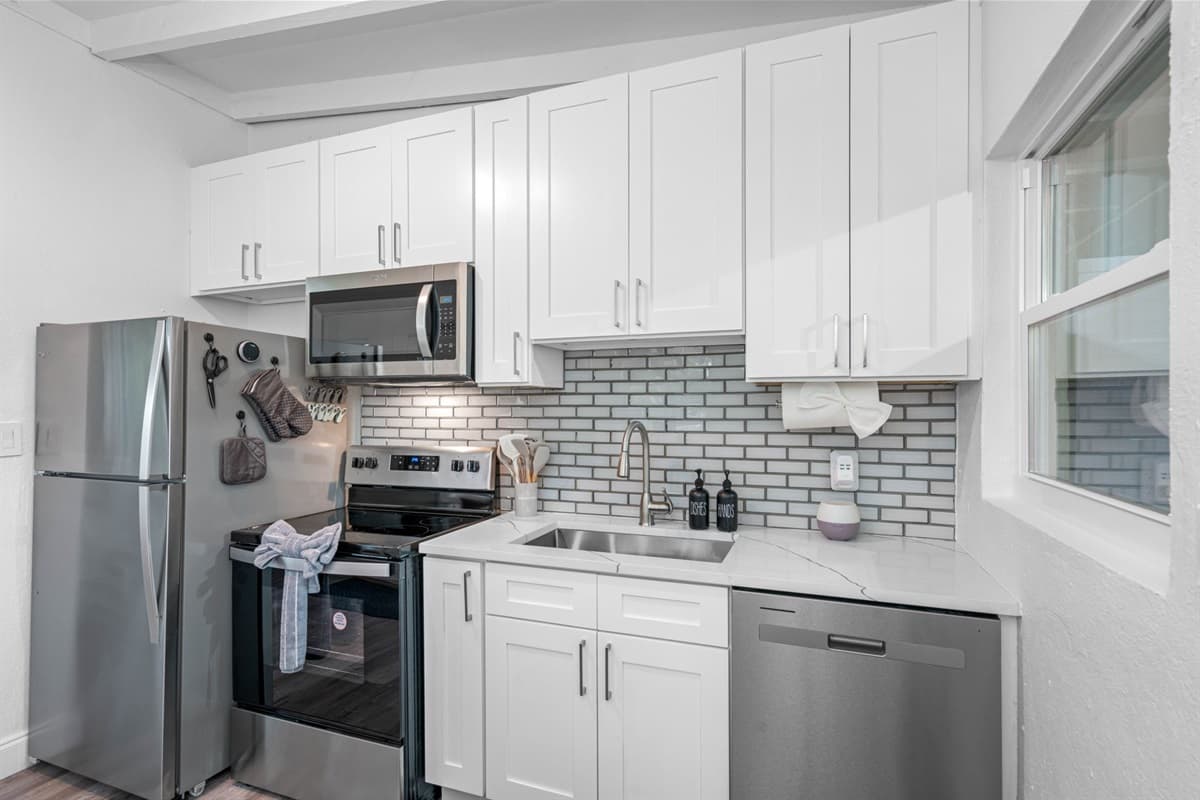 The kitchen is anchored by a modern stove and oven combo, allowing for a wide range of cooking techniques, from baking and roasting to sautéing and simmering.