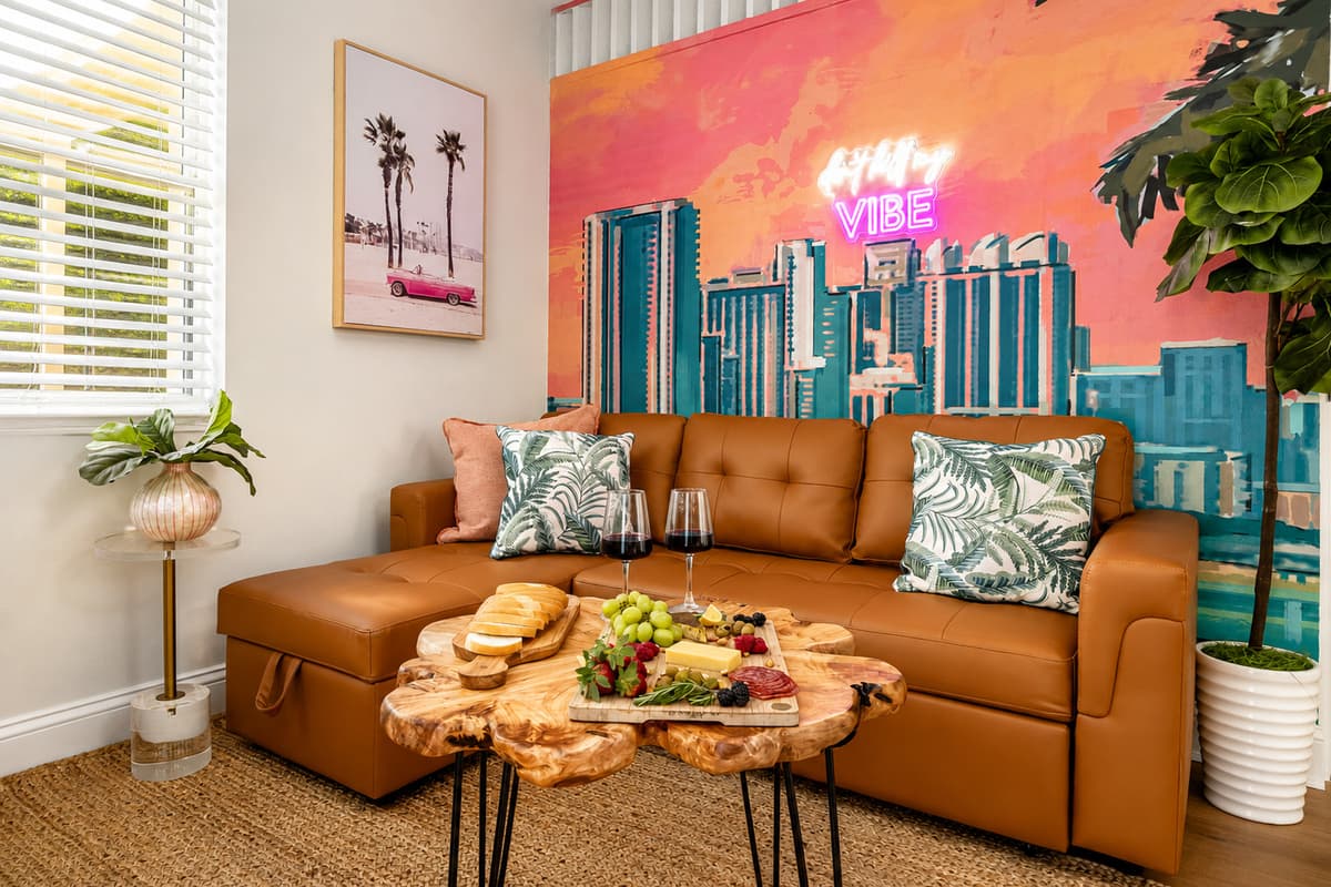 Kick back on the comfortable sofa while enjoying the vibrant coastal décor, colorful mural, and inviting atmosphere.