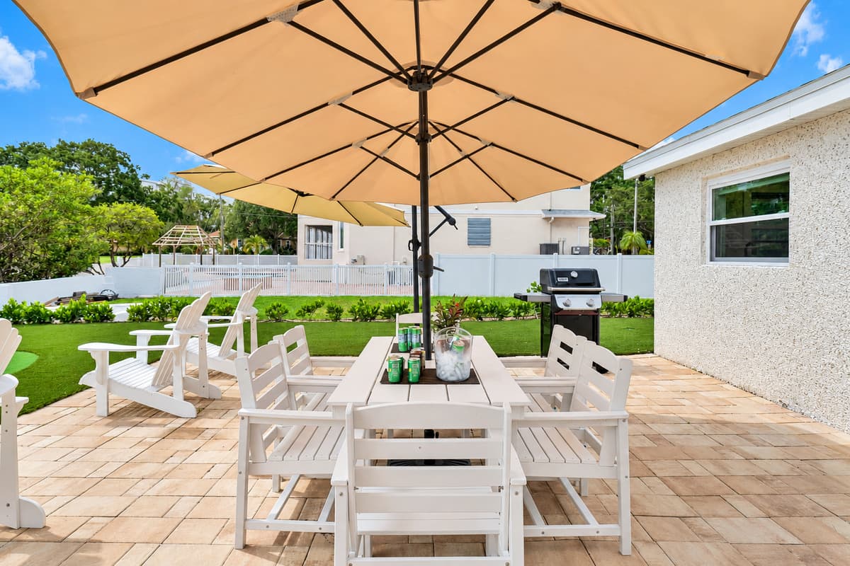 A long table for long dinners. The outdoor dining set seats the whole group under a big shade umbrella. Pass the plates and enjoy the breeze.