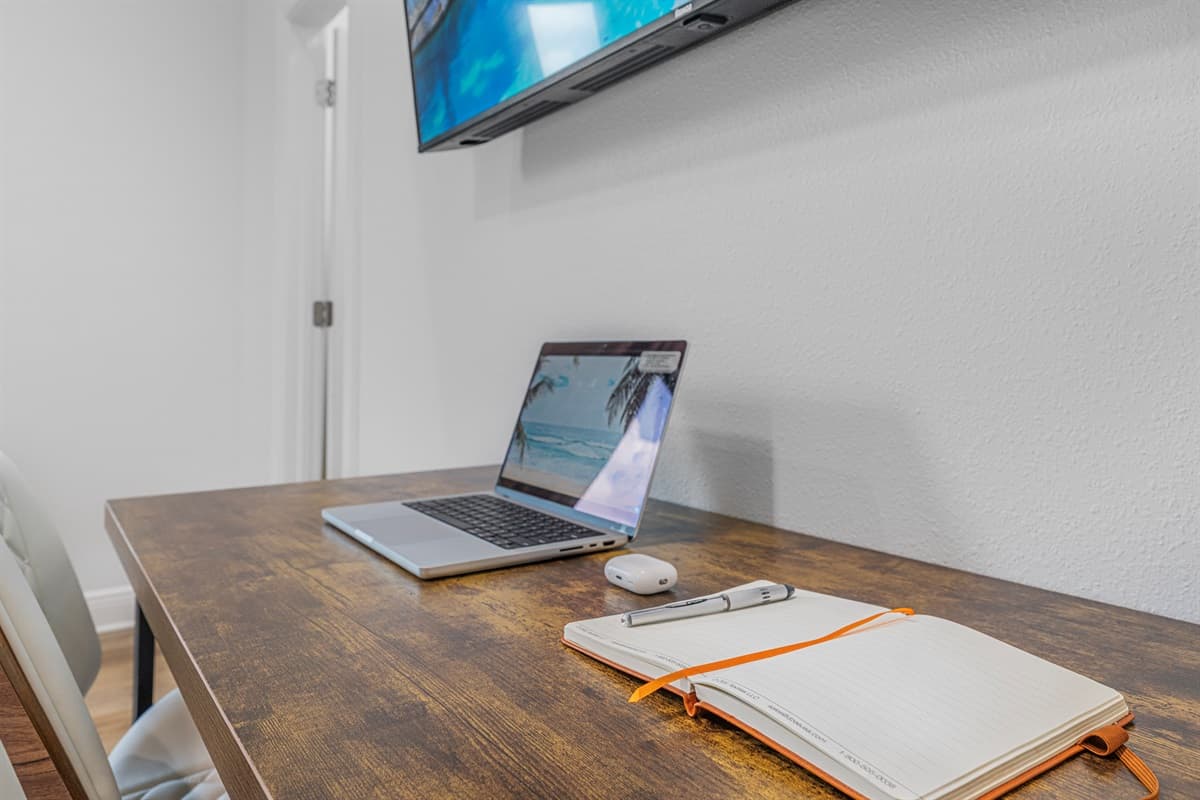 Additional workspace angle featuring desk, chair, and mounted TV—perfect for staying connected during your stay.