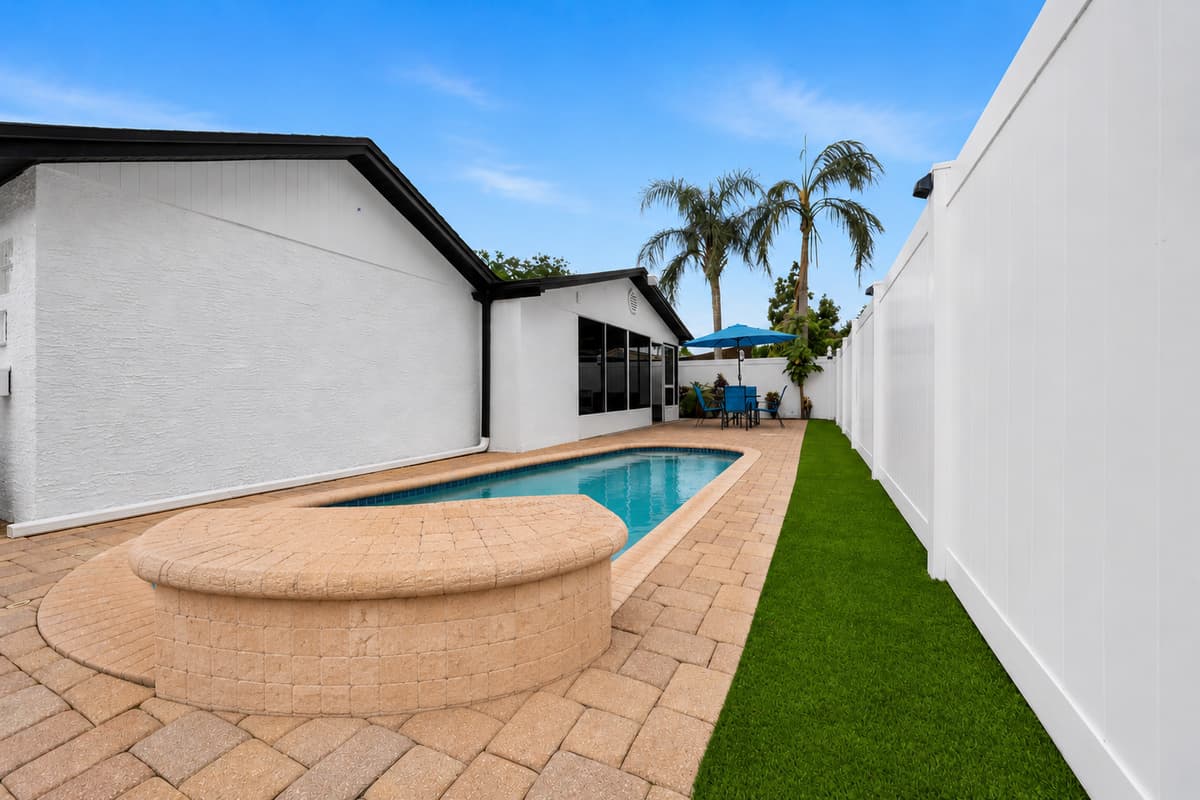Private swimming pool surrounded by a fully fenced backyard, providing a peaceful and private setting for relaxation and family fun.