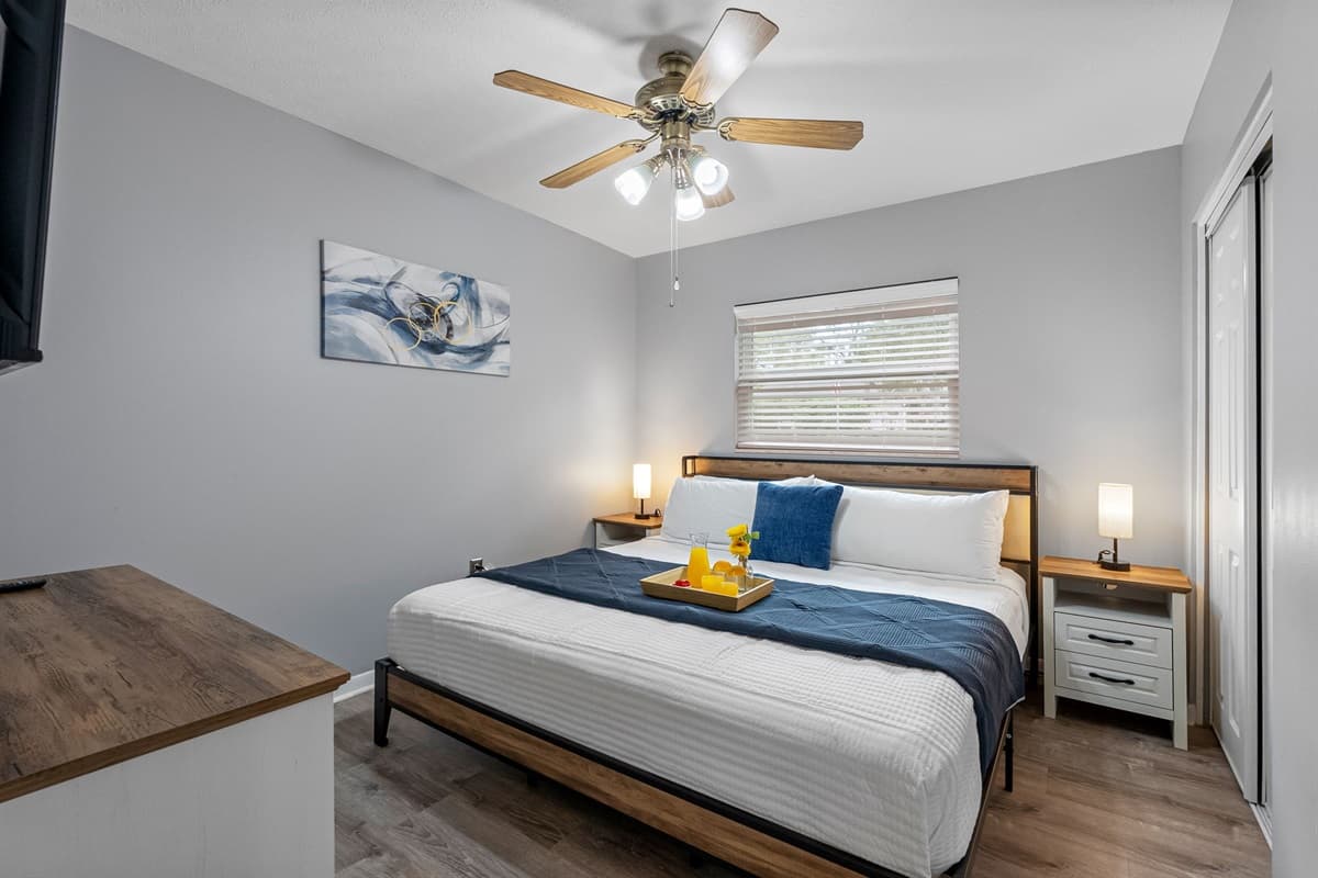 Relax in this cozy king bedroom featuring plush bedding and calming neutral tones.
