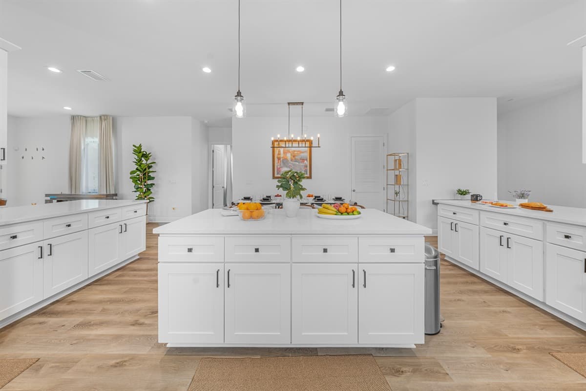 Stunning kitchen with a large central island, pendant lighting, and ample space for cooking and gathering.