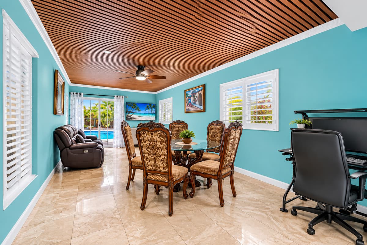 Flexible space featuring a dining table and dedicated workspace for remote work or trip planning.