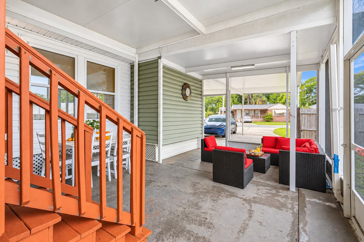 Covered patio with multiple seating areas—perfect for entertaining or unwinding.