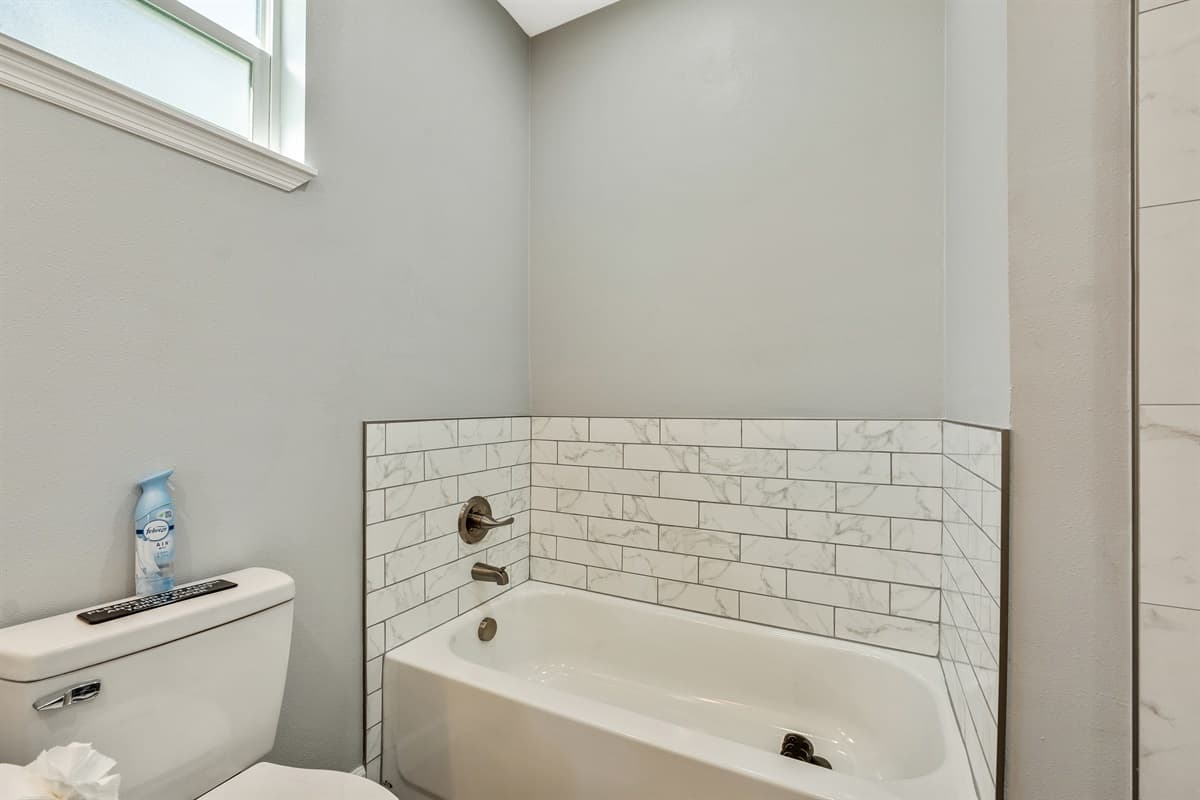 Sink into the soothing depths of the bathtub, where warm water envelops you in a cocoon of tranquility.