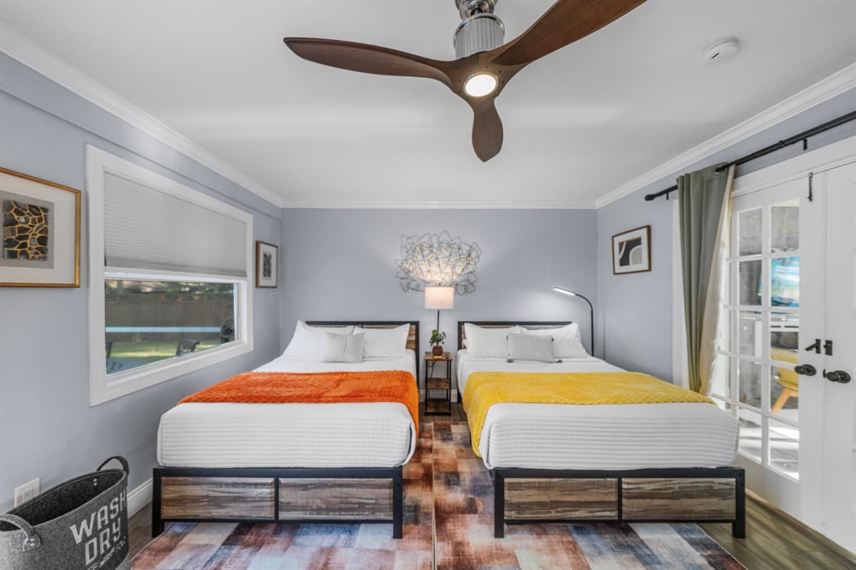Enjoy plenty of sleeping space in this inviting bedroom with two double beds and cozy, stylish décor.
