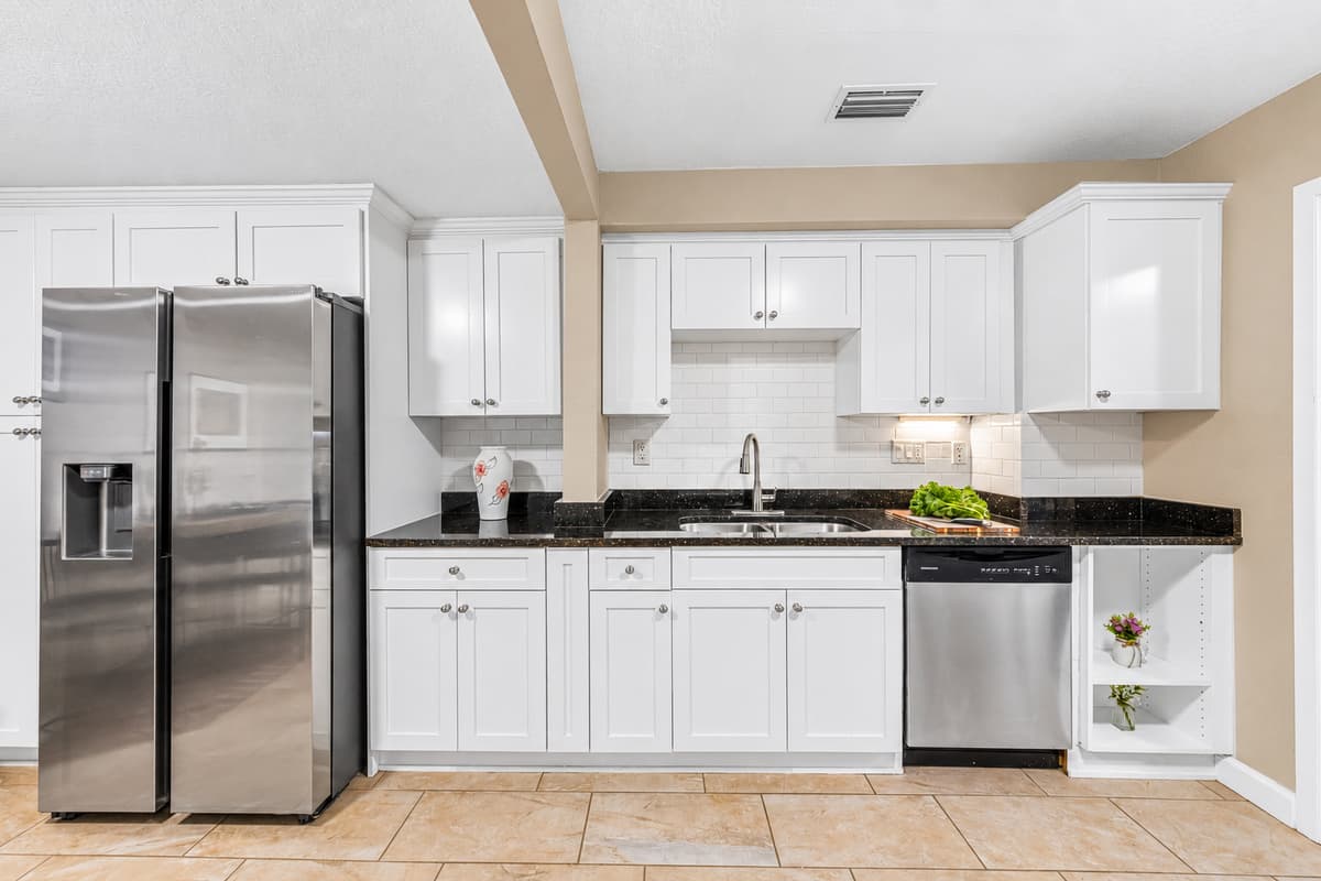 Modern kitchen featuring stainless steel appliances, sleek cabinetry, and ample counter space for cooking.