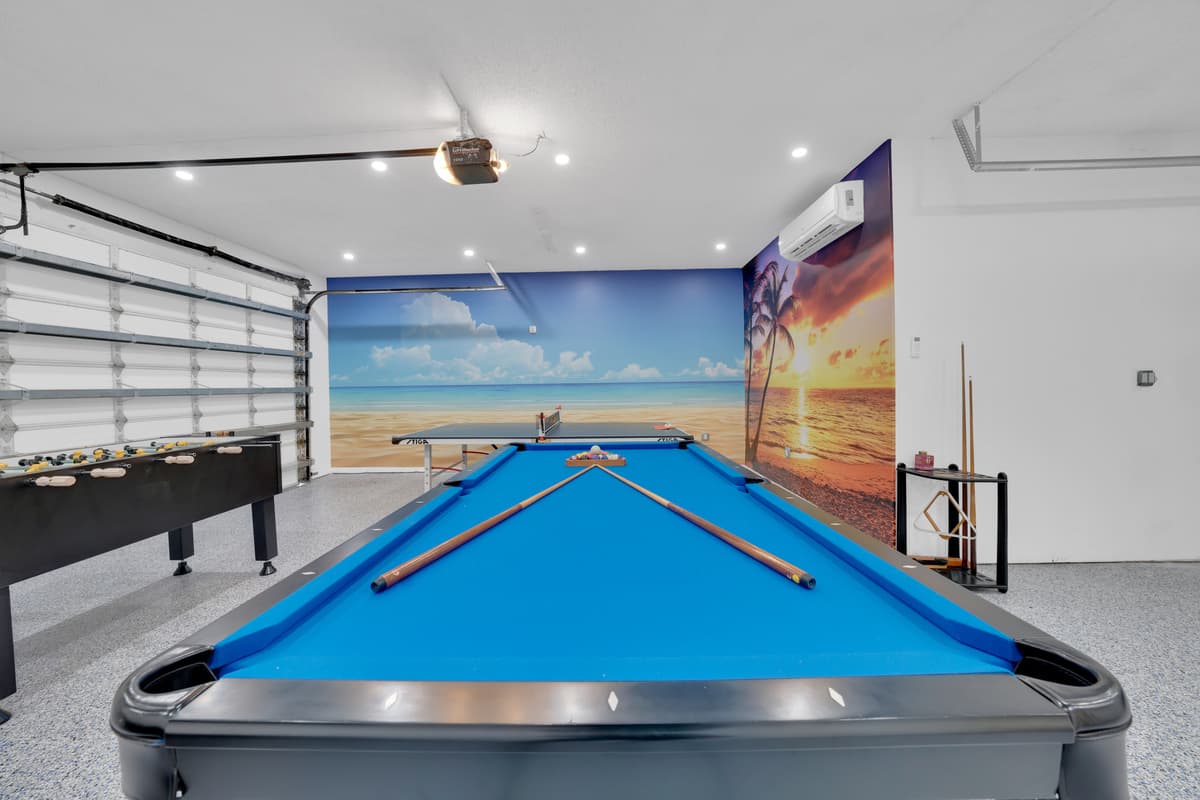 Enjoy the ultimate game room inside! A full-size blue pool table, ping-pong, and foosball all waiting for you. This game room is perfect for endless fun.