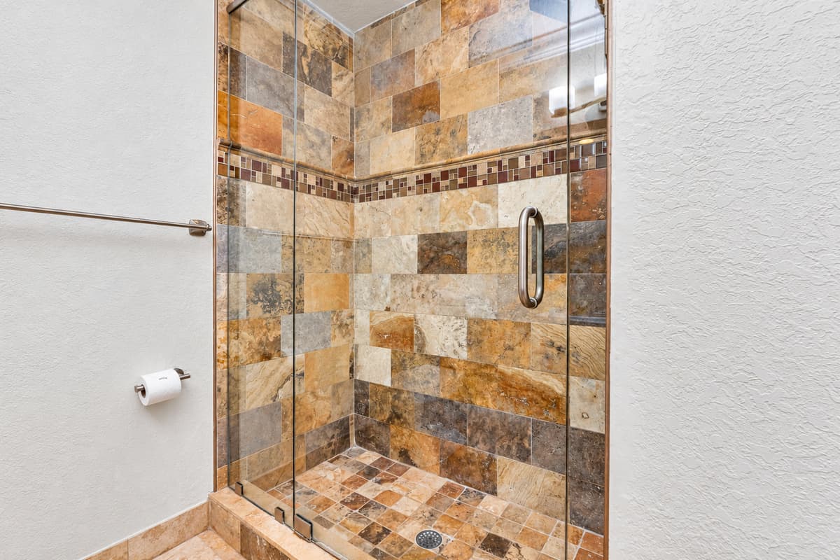 A walk-in shower with glass enclosure offers a refreshing alternative, ideal for a quick rinse or rejuvenating morning routine.
