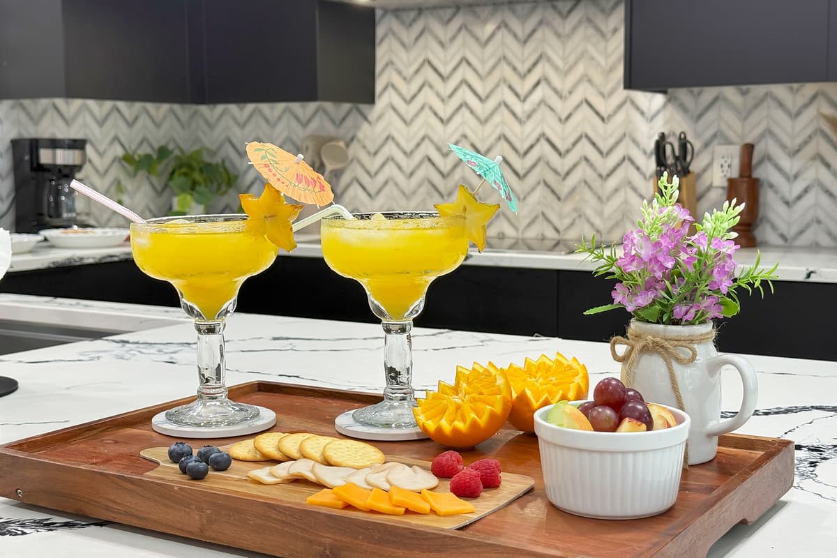 Cheese board, drinks poured, nothing rushed — this is the "we just got here and already feel at home" moment in one frame.