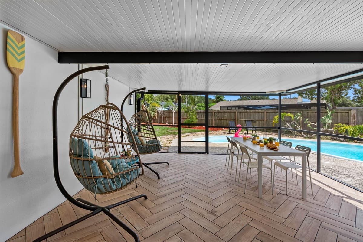 Fully enclosed and designed for comfort, your outdoor retreat features stylish furnishings, soft lighting, and plenty of seating around the pool for friends and family to gather.