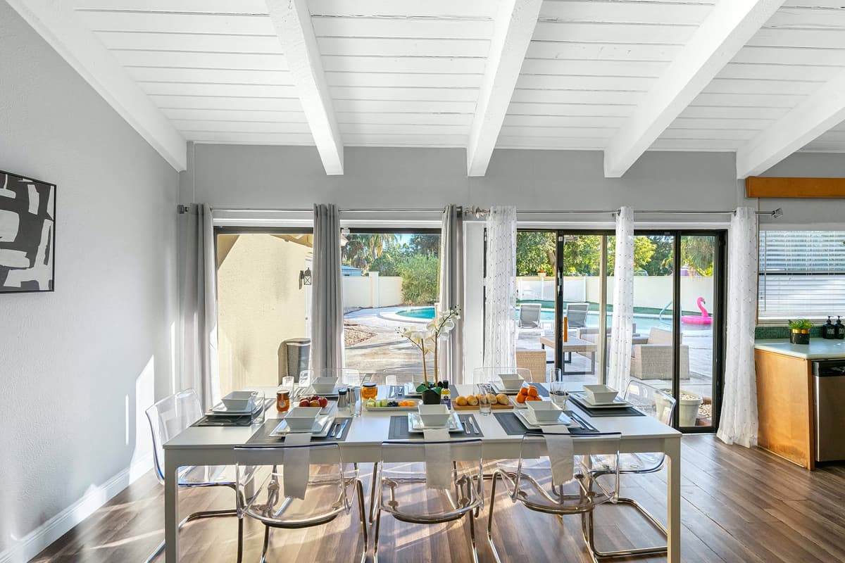 Enjoy meals with a beautiful view of the pool and patio through wide sliding glass doors.