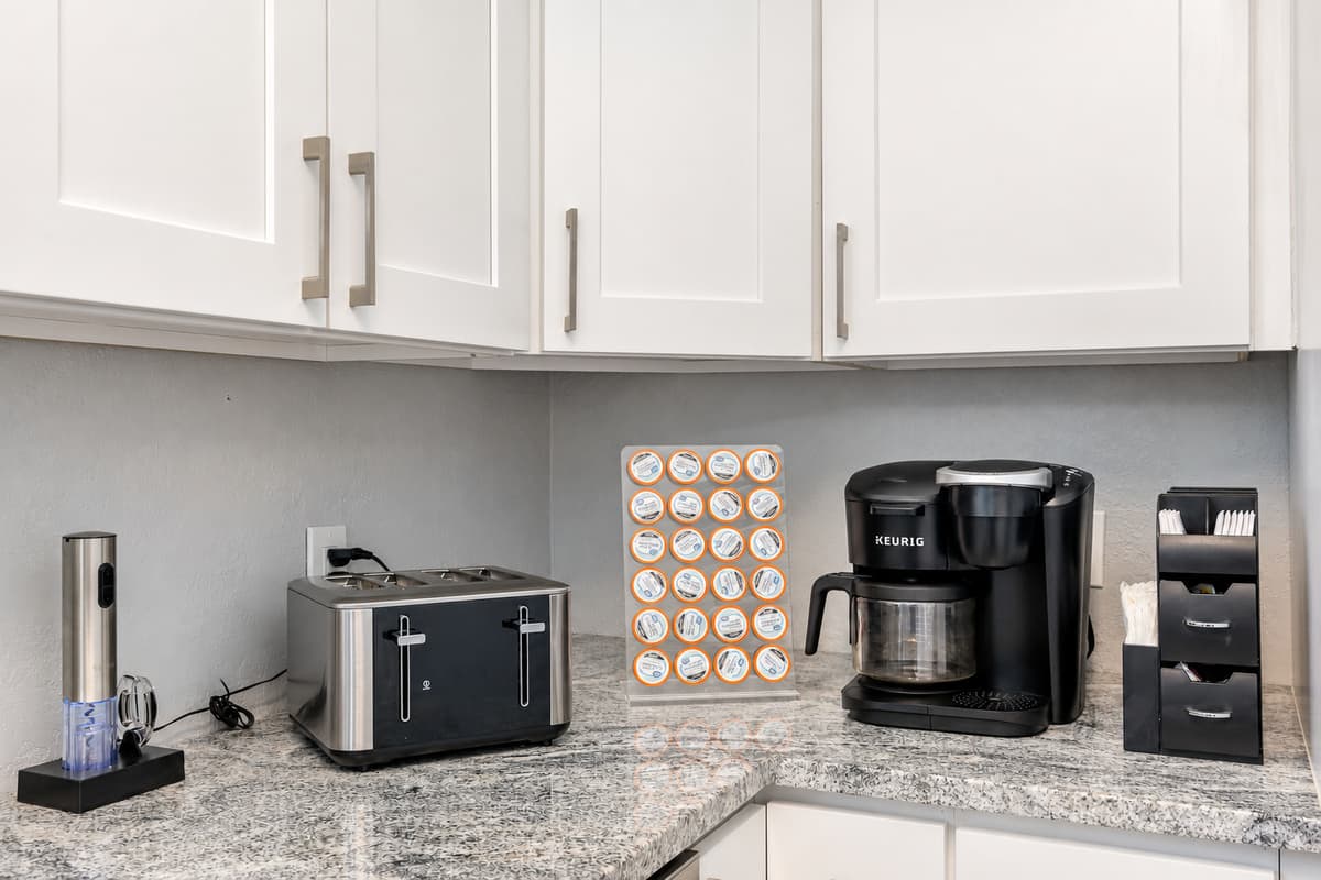 . The bright white cabinets and cupboards provide a clean and fresh look.