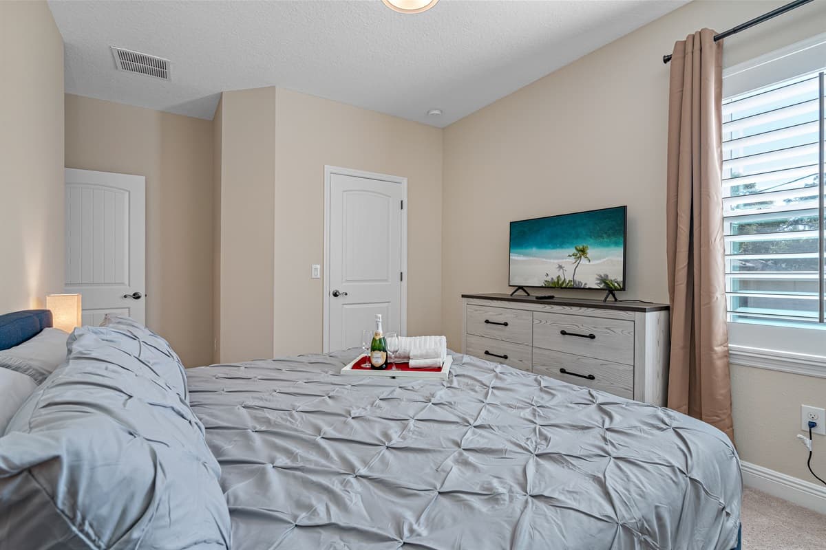Sleep safe and sound on the comfort of your home away from home. Comfortable bedroom with king  sized bed, smart TV and drawers.
