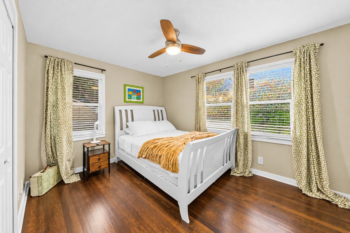 Cozy bedroom with natural light, comfortable bed, and calming decor for a restful night’s sleep.