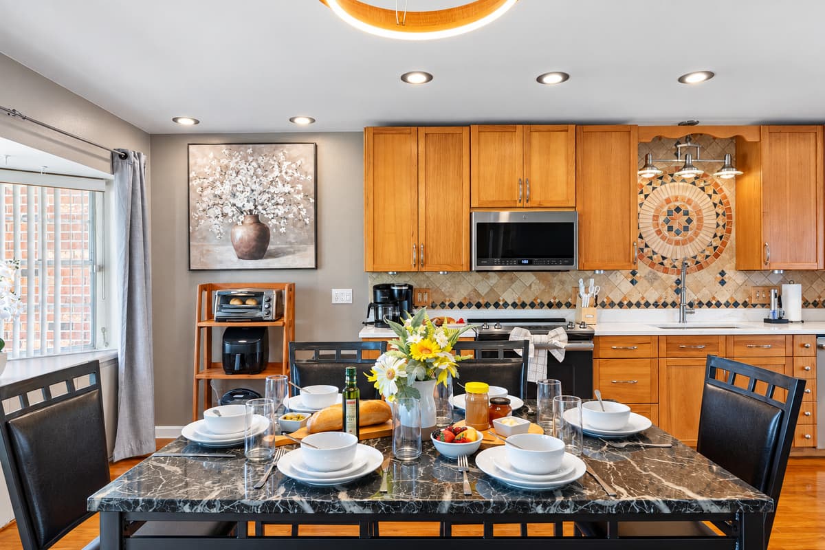 Natural wood cabinetry meets modern stainless steel appliances, creating a perfect balance between rustic charm and modern style.