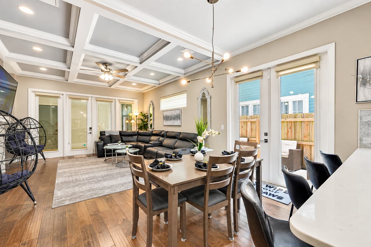 Adjacent to the dining area, the open-concept living room beckons with its plush seating and entertainment options, ensuring that even as you dine, you remain connected to the lively atmosphere of the home.