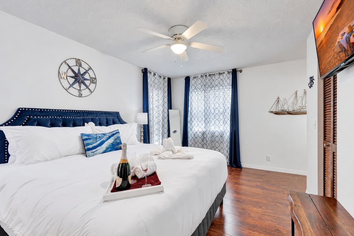 Beautiful wood flooring stretches across the bedroom, adding warmth and a sense of elegance to the space.