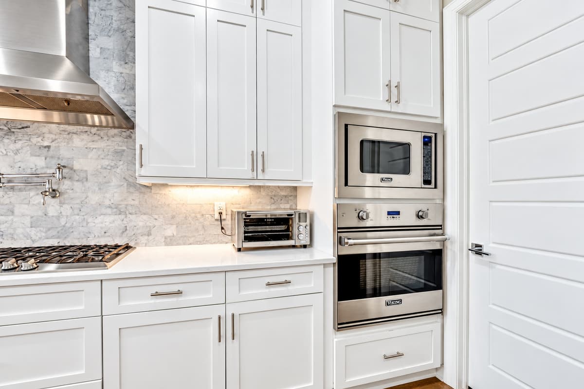 The stainless steel appliances stand ready to assist, from the state-of-the-art oven to the versatile cooktop, ensuring that every dish is cooked to perfection.
