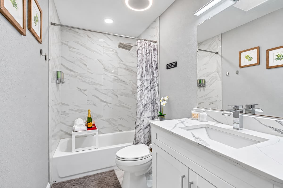 Beautiful bathroom equipped with sink, toilet, and a bathtub and shower combo. Enjoy a relaxing bath after a long day of travel from your home to your home away from home. If you think this property is for you, send us an inquiry right away!