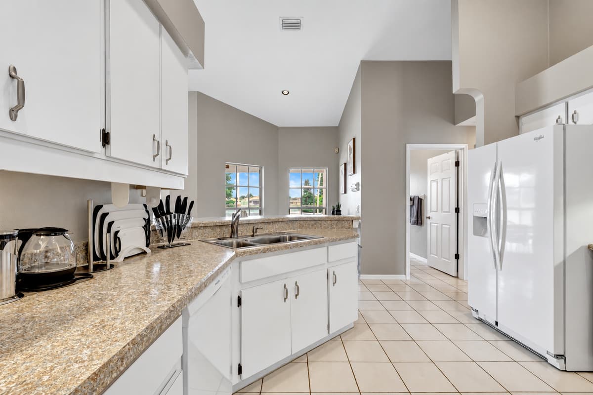 In this kitchen, functionality meets style effortlessly. The exquisite white wooden cupboards, meticulously crafted with precision and unwavering attention to detail.