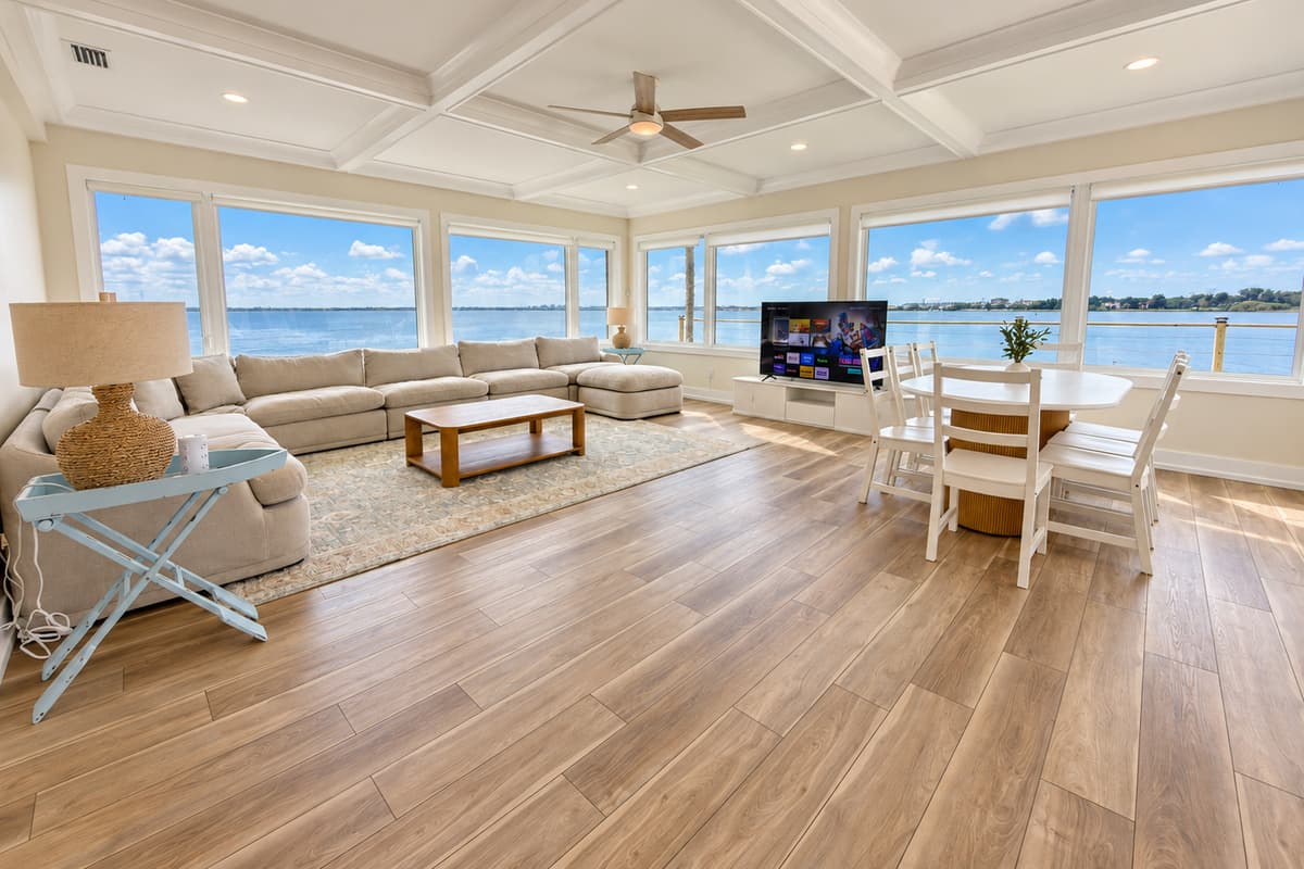 Waterfront living room with comfortable seating and wide water views.