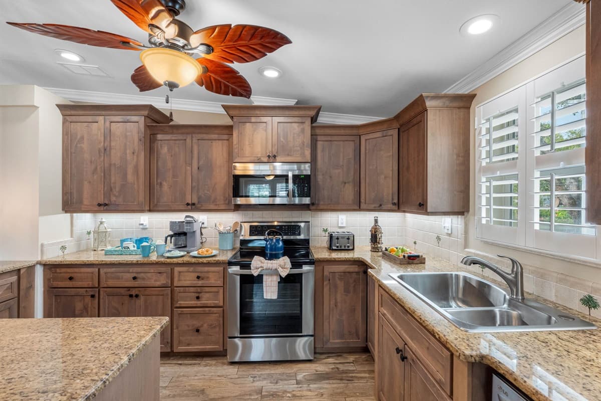 Enjoy a spacious, fully stocked kitchen complete with pendant lighting, a large island, and plenty of prep space for group meals.