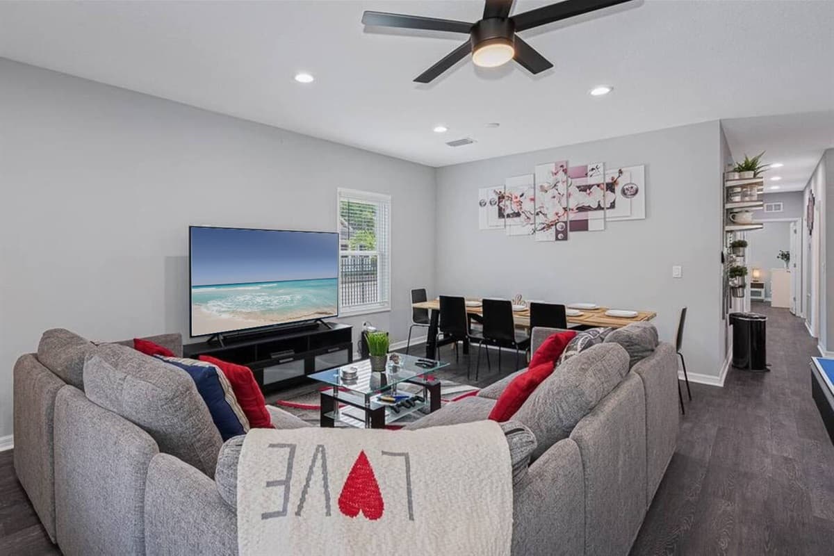 To complement the modern aesthetic, sleek and minimalist furniture pieces such as a contemporary coffee table and minimalist shelving units complete the living room ensemble.