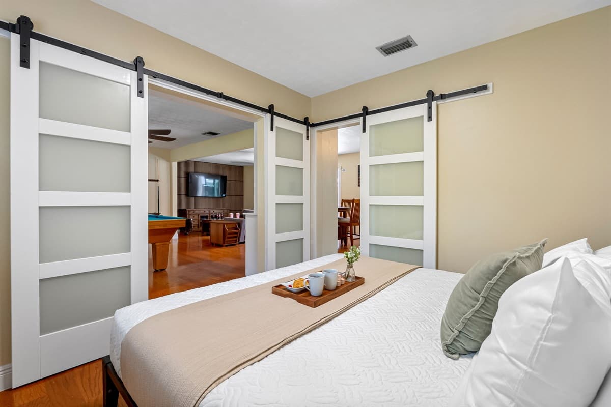 Bright and cozy king bedroom featuring soft linens and calming décor.