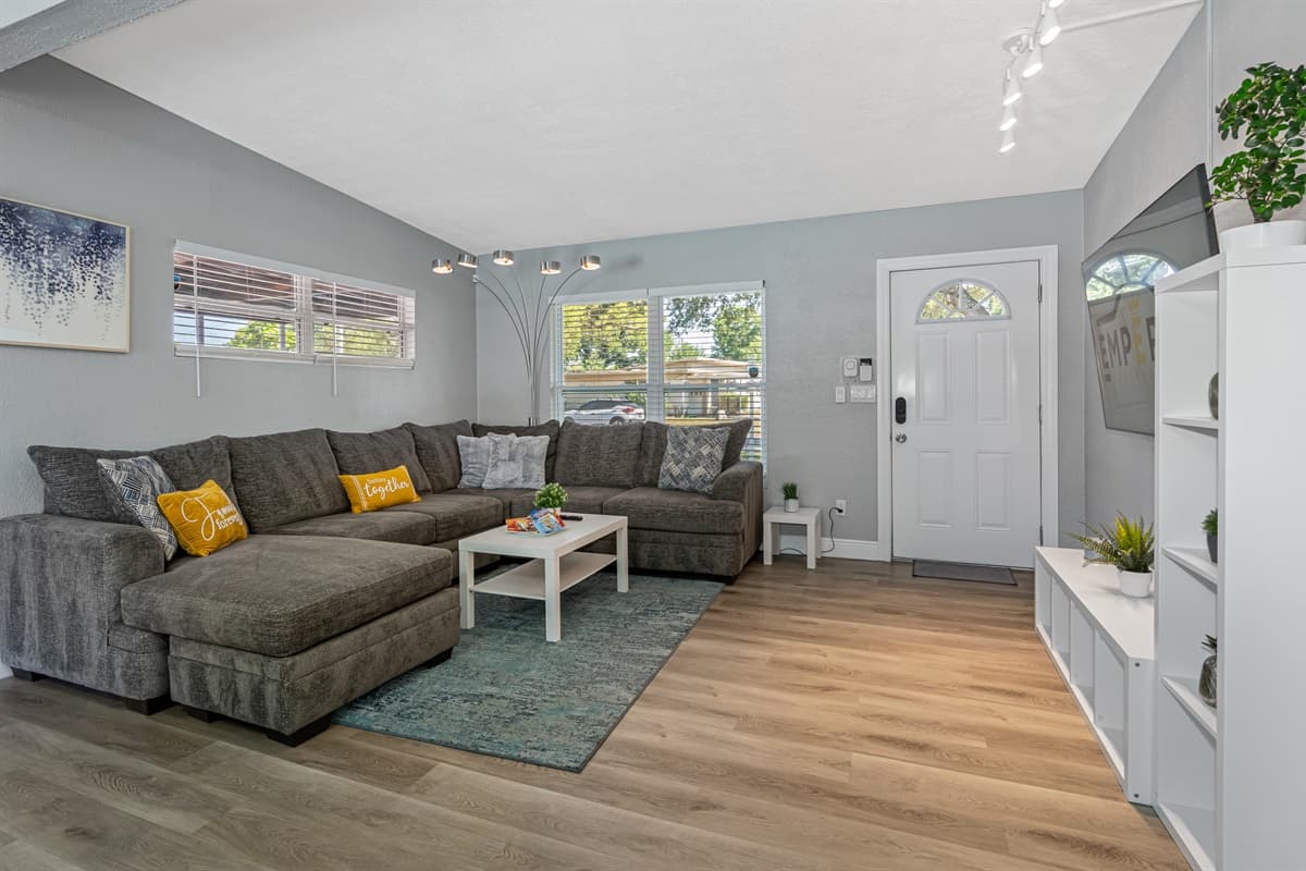In front of the couch, there is a sleek white coffee table, which adds a touch of sophistication to the room.