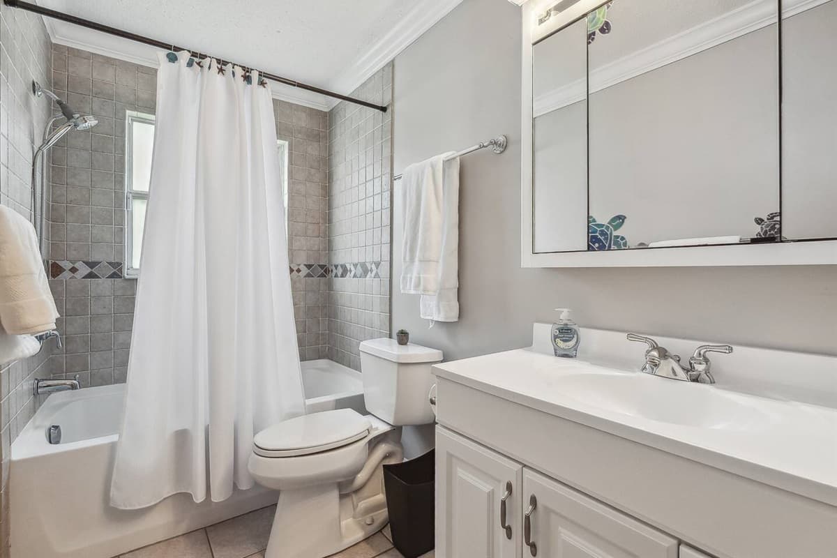 The tub and shower combination, with its sleek design and premium finishes, offers a haven for relaxation.