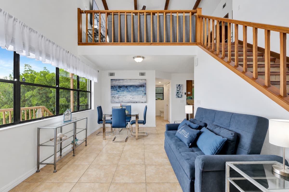 Adjacent to the couch, a charming seating area by the window awaits, offering a prime vantage point to soak in the breathtaking views of the surrounding landscape.