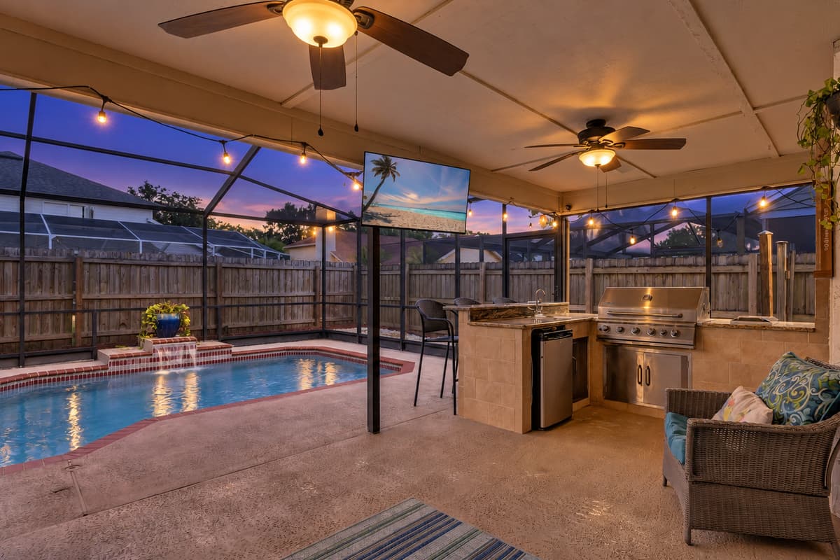 Featuring cozy seating arrangements and a compact outdoor kitchen complete with a grill.