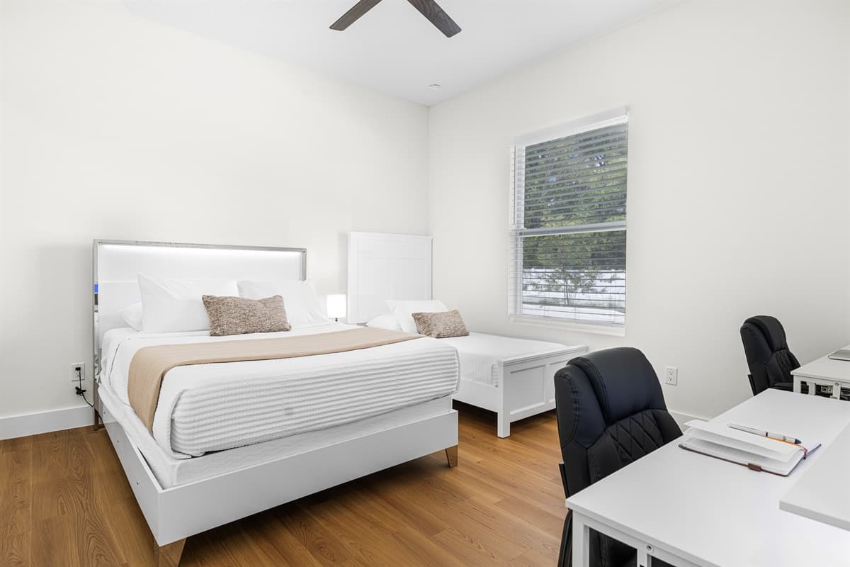 Comfortable bedroom with natural light and minimalist design for a restful stay.
