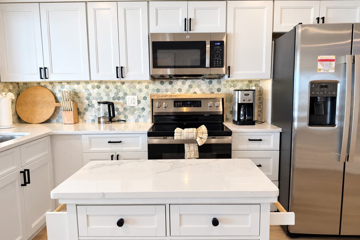Kitchen with an island, stainless appliances and space to prepare meals.