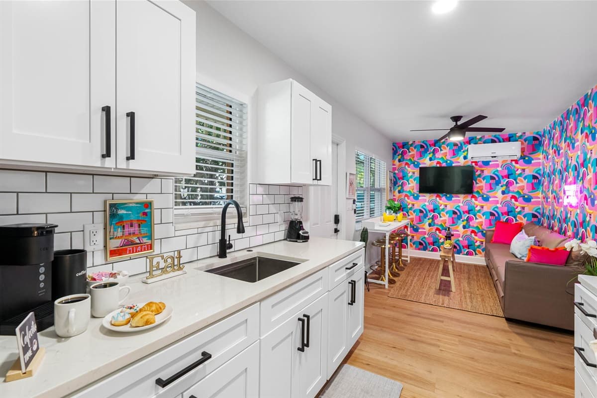 The seamless, minimalist design of the white cabinetry offers ample storage space, keeping everything organized and within easy reach while maintaining a clean, uncluttered look.