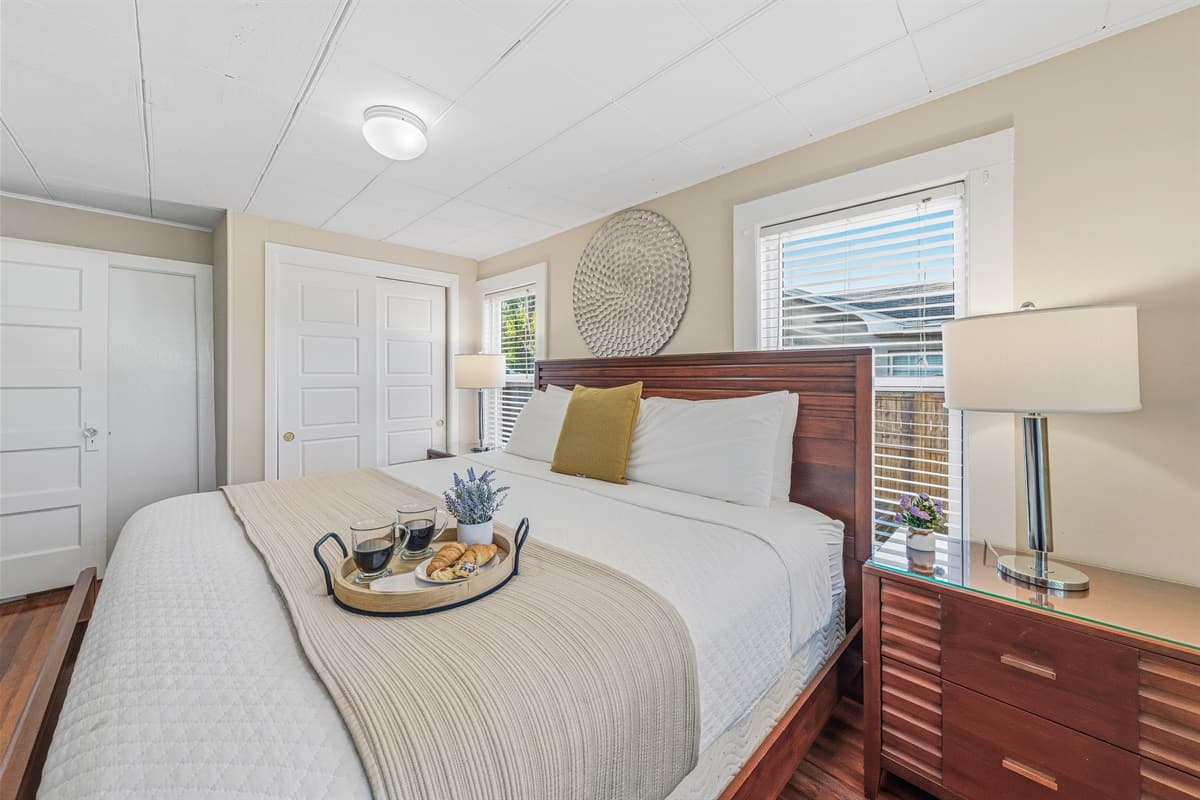 Bright and airy bedroom with cozy bedding and natural light.
