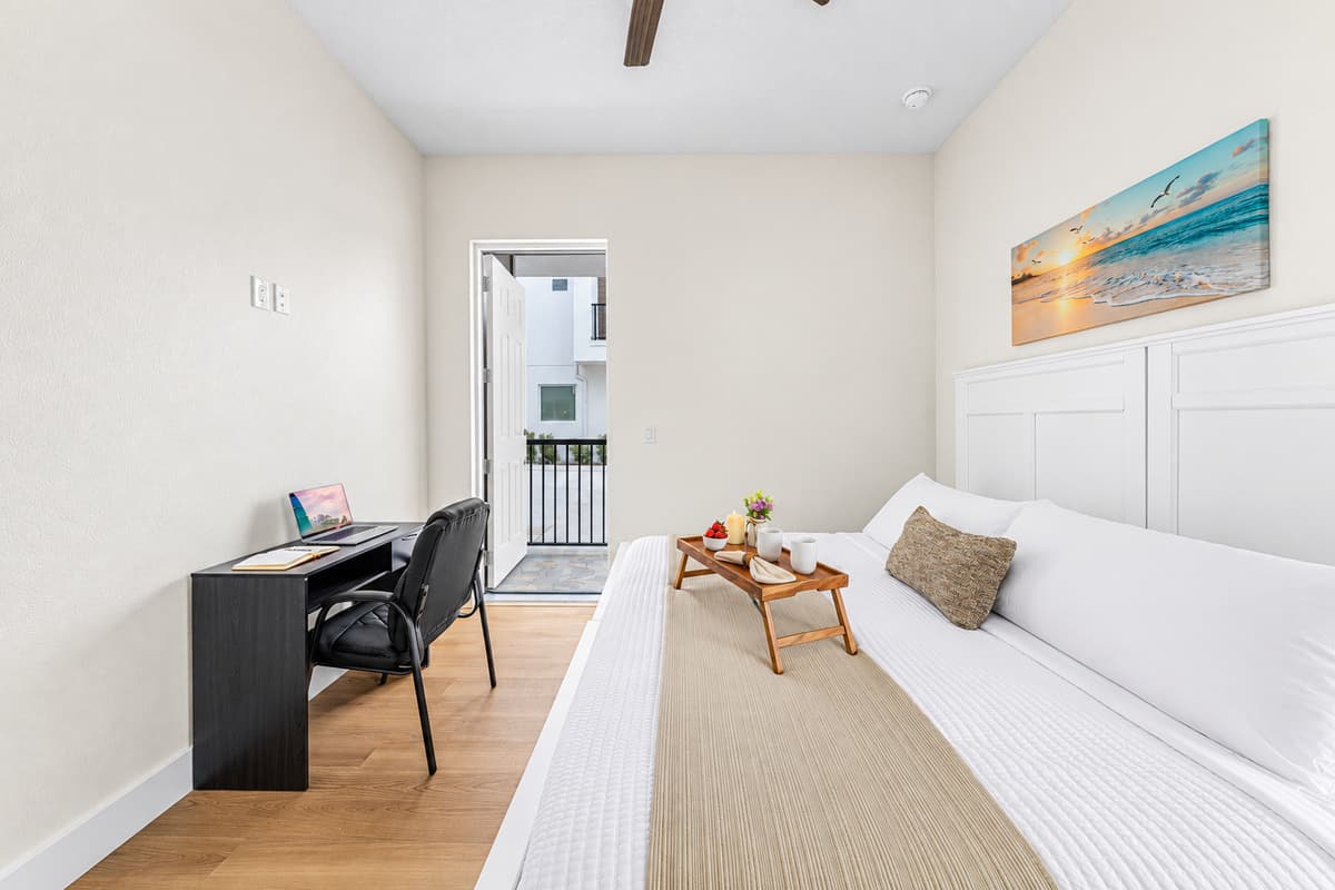 Bright bedroom with clean design, workspace, and relaxing ambiance.
